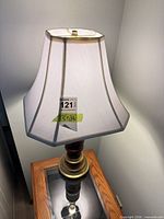 Full view of lamp showing wood and brass base with fabric shade