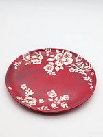 Top view of red plate with white floral design