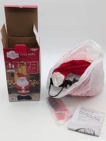 Open box showing bagged inflatable, instruction sheet and packaging