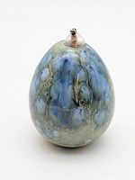 Full view of lamp showing egg-shaped form, glaze and metal wick