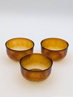 Three amber glass bowls grouped