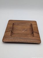 Top view of wooden square tray highlighting recessed center and wear