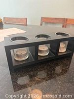 Front view showing three glass votive inserts in wood holder