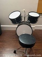 full view of drum kit and stool