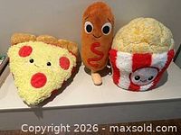 All three plush toys side by side on surface