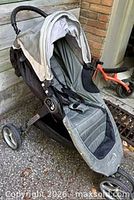 Overall view of Baby Jogger City Mini stroller, grey seat, black frame, three wheels