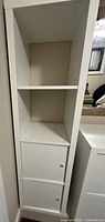 Full front view showing open shelving and two cupboard doors