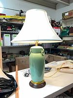 Lamp with shade illuminated showing shape, glaze, shade style