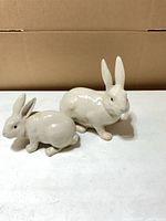 Front view of both ceramic rabbit figurines