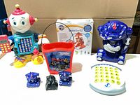 Group shot showing Ready Freddy robot, handheld controller, Transformers pail with mini figures, Warrior EZ robot and A-to-Z board
