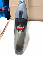 Front view showing Bissell logo, 3-in-1 VAC label, transparent dirt cup