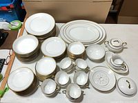 overhead view of complete Noritake Goldena Nippon dinnerware set showing all 88 pieces