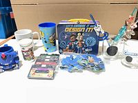 Group shot of entire lot showing mugs, cups, lunch box, cassettes and straws