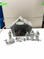 Full nativity set arranged with stable, figures and animals