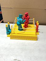 Overall view of game showing teal and red robots inside yellow ring