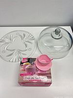 Platter, dome lid, retail box, and one pink silicone teacup mold displayed
