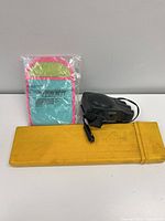 All three items grouped: packaged mitt, black 12 V fan with cord and plug, yellow rectangular case