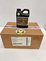 Bottle atop sealed shipping box showing product front label