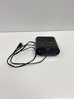Front view showing Sony branding, LED display, AM/FM scale, attached power cord