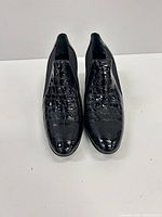Top view of both shoes showing croc embossing and slip-on design