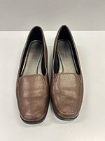 Front view of both loafers showing leather uppers and toe shape