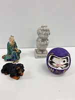 Group shot of all four figurines showing scale and forms