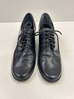 Front view of both shoes showing toe condition and laces