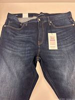 Front view of jeans showing overall condition and color