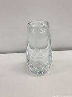 Front view of clear glass vase displaying etched floral design