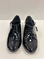 Front top view of both booties showing patent leather finish and overall condition