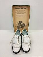 Shoes displayed in front of original Etonic box