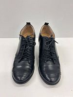 Front view of pair of black lace-up ankle boots