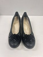Front and side view of both shoes displaying overall appearance and toe embellishments