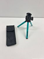Tripod standing with pouch alongside