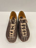 Front view showing leather uppers, laces, stitching