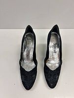 top view of both pumps showing lace overlay, insoles with branding, condition of uppers