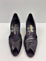 Front view of both pumps showing peep toe and knotted vamp