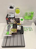 Complete lot stacked showing all boxed and loose items on mesh tray