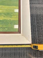 Front lower corner showing painting, frame, liner and measuring tape at about 34 in