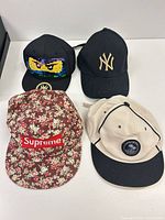 Top view of all four caps showing logos and colors