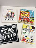 Front covers of the four books arranged on table