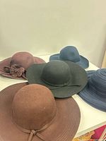 Five hats displayed, showing colours and styles