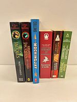 Front spines showing six fantasy paperbacks lined up