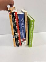 Six books standing side by side showing spines
