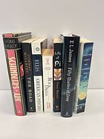 Seven books standing upright, spines visible