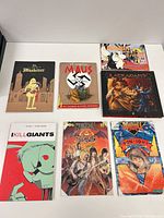 All seven books laid out front covers visible