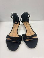 Front view of sandals showing straps and cork insole