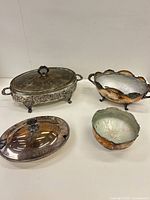 Group shot of all four metal serving and decorative pieces
