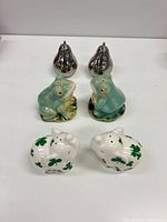 Front view of all three shaker pairs: chrome pears, green frogs, white shamrock elephants
