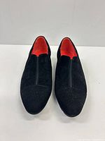 Top view of both loafers showing suede upper and red leather interior